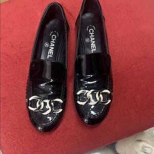 CHANEL Glossy Black Loafers with Silver Chain Detail